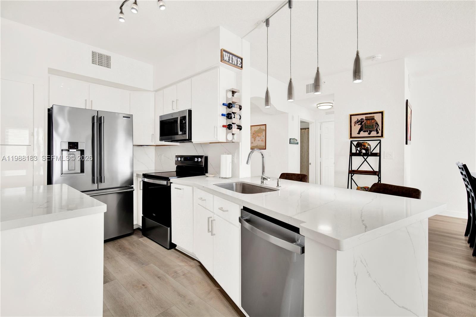 9021 Southwest 94th Street, Unit 308 Miami, FL 33176 - Photo 2 of 35 a kitchen with a sink a stove and refrigerator