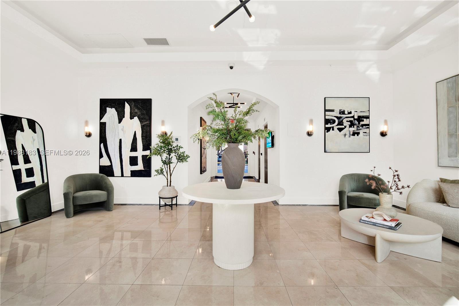 9021 Southwest 94th Street, Unit 308 Miami, FL 33176 - Photo 23 of 35 a living room with furniture and a chandelier