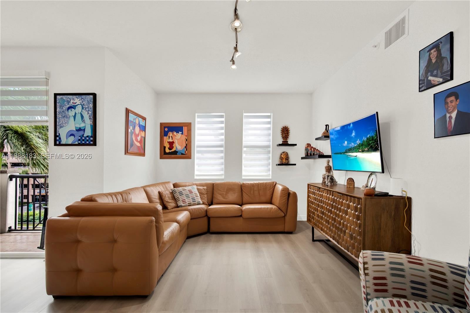 9021 Southwest 94th Street, Unit 308 Miami, FL 33176 - Photo 6 of 35 a living room with furniture a flat screen tv and a couch