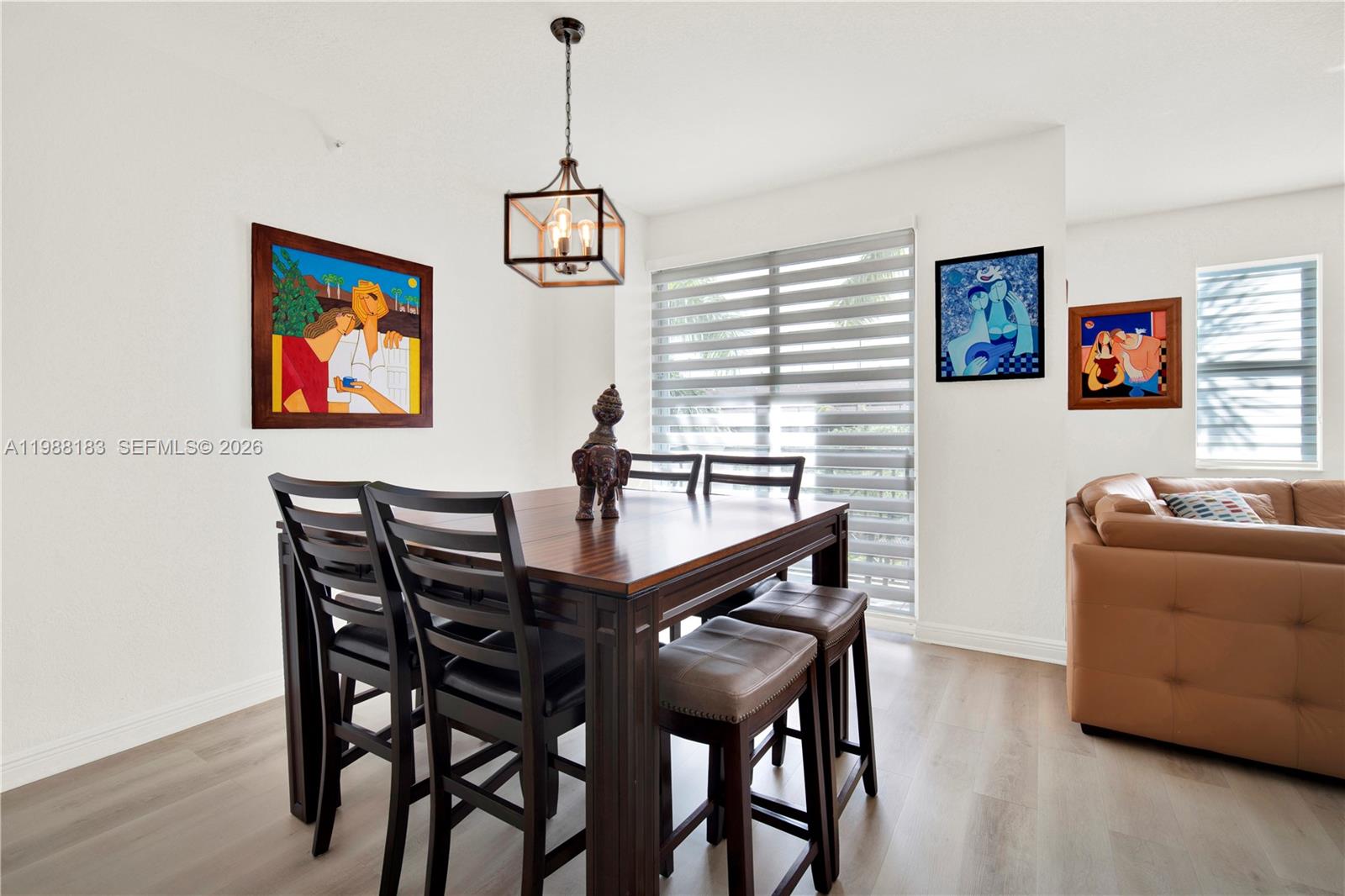 9021 Southwest 94th Street, Unit 308 Miami, FL 33176 - Photo 9 of 35 a view of a dining room with furniture and wooden floor