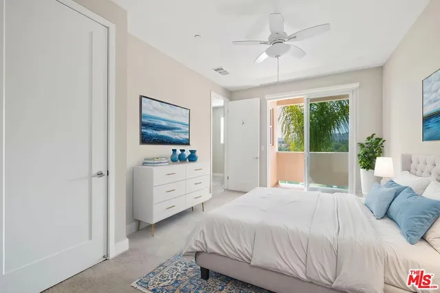 a bedroom with a white bed and a dresser