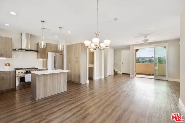 an open kitchen with white cabinets and stainless steel appliances