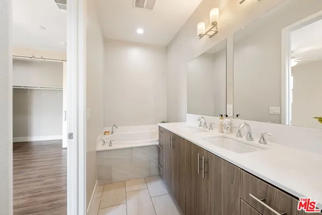 a bathroom with a double vanity sink mirror and double