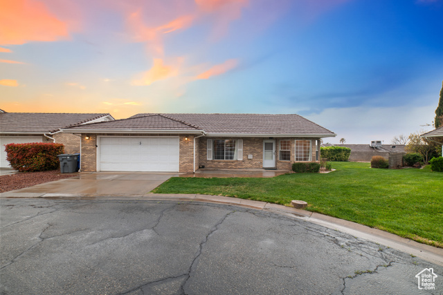 1090 East 700 South, Unit 10 St. George, UT 84790 - Photo 1 of 1 Single story home with a tiled roof, an attached garage, brick siding, driveway, and a yard