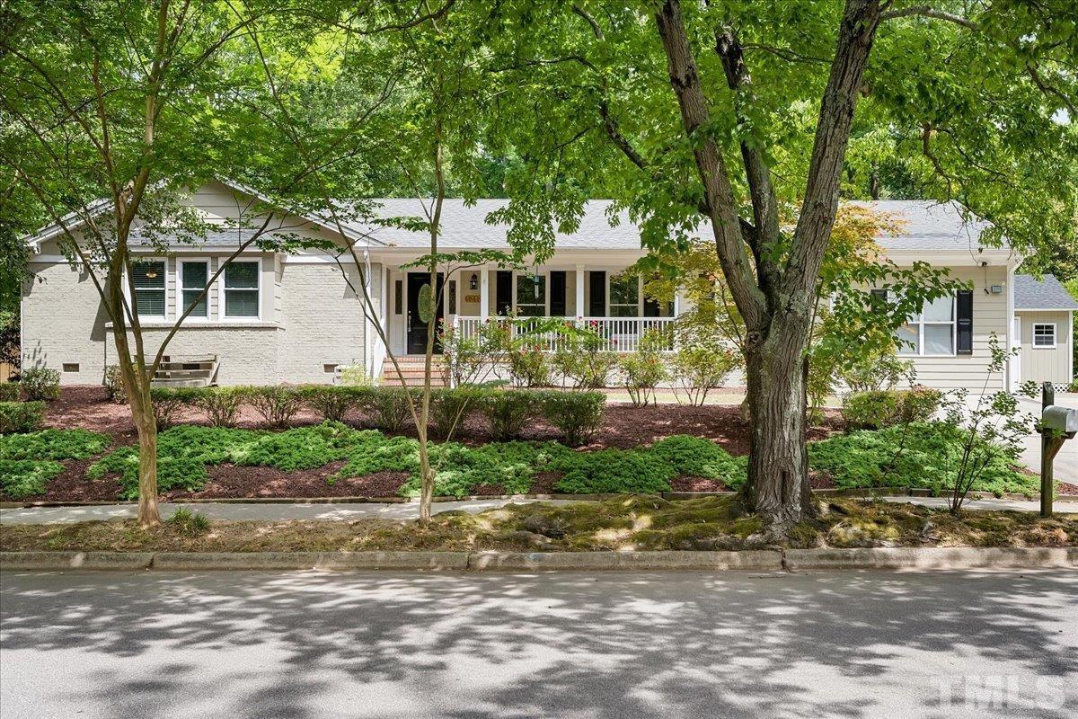 1313 Falls Church Road Raleigh, NC 27609 - Photo 1 of 40 a front view of a house with a garden