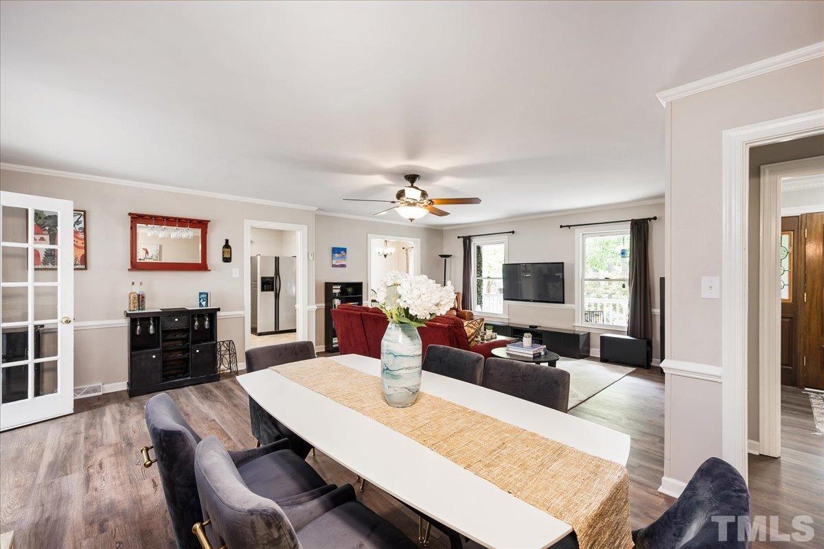 1313 Falls Church Road Raleigh, NC 27609 - Photo 13 of 40 a living room with furniture a dining table and a fireplace