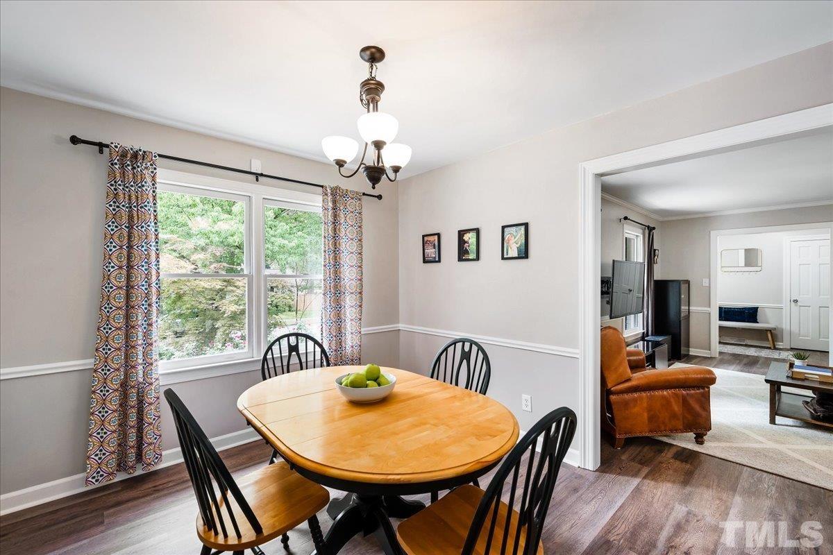 1313 Falls Church Road Raleigh, NC 27609 - Photo 18 of 40 a view of a dining room with furniture window and wooden floor