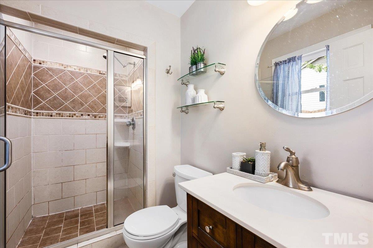 1313 Falls Church Road Raleigh, NC 27609 - Photo 25 of 40 a bathroom with a sink toilet and shower