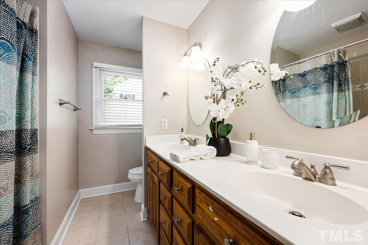 1313 Falls Church Road Raleigh, NC 27609 - Photo 30 of 40 a bathroom with a sink and a mirror