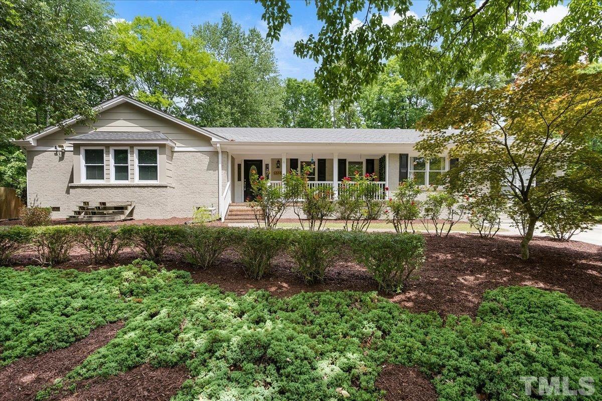 1313 Falls Church Road Raleigh, NC 27609 - Photo 3 of 40 a front view of a house with garden