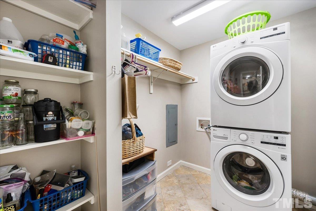 1313 Falls Church Road Raleigh, NC 27609 - Photo 32 of 40 a view of a storage and utility room with washer and dryer