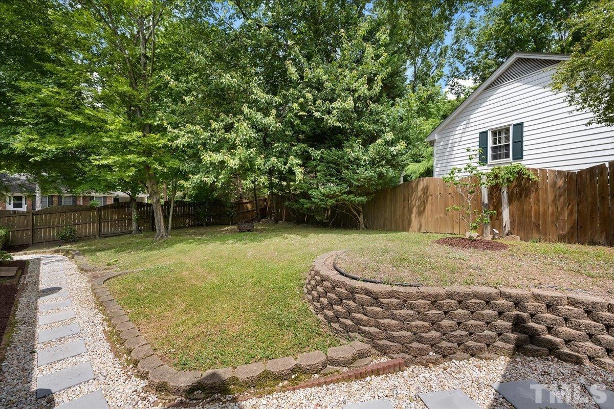 1313 Falls Church Road Raleigh, NC 27609 - Photo 37 of 40 a backyard of a house with basket ball court and outdoor seating