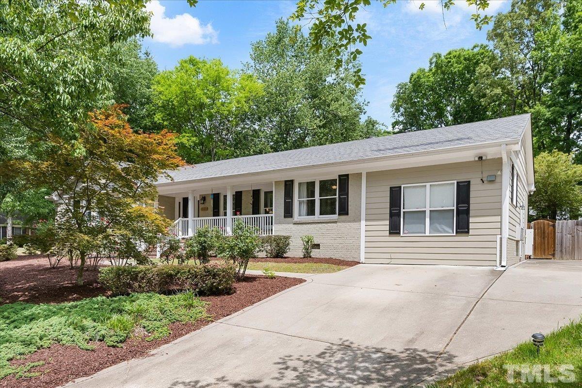 1313 Falls Church Road Raleigh, NC 27609 - Photo 4 of 40 a front view of a house with a yard and potted plants