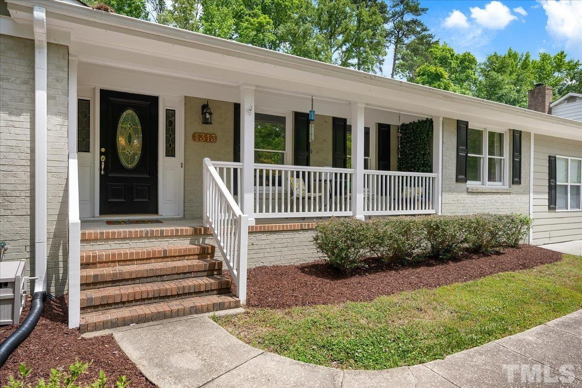 1313 Falls Church Road Raleigh, NC 27609 - Photo 5 of 40 a view of a house with a yard