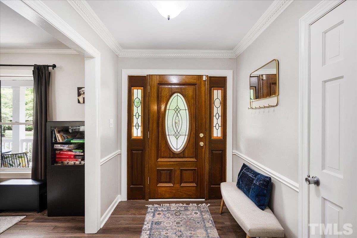 1313 Falls Church Road Raleigh, NC 27609 - Photo 6 of 40 a view of an entryway with a mirror and a window