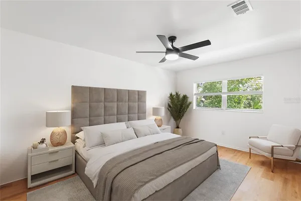 a bedroom with a large bed and a window