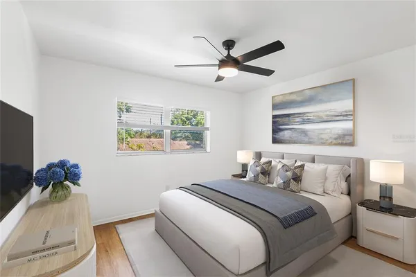 a bedroom with a bed and a chandelier