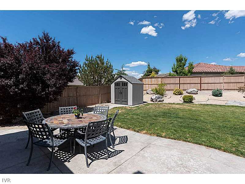 2525 Country Falls Lane Reno, NV 89521 - Photo 27 of 34 a view of a backyard with table and chairs with plants and wooden fence