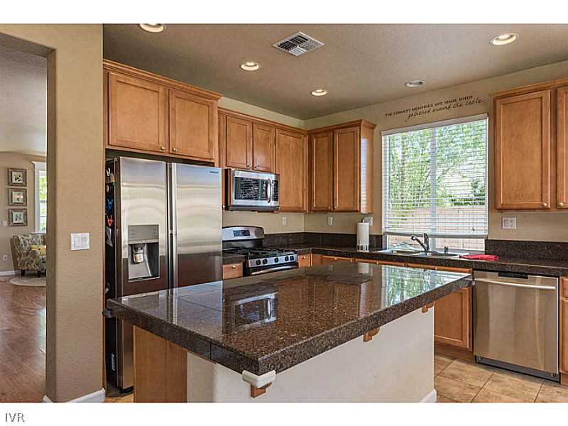 2525 Country Falls Lane Reno, NV 89521 - Photo 8 of 34 a kitchen with kitchen island granite countertop a sink stove and refrigerator