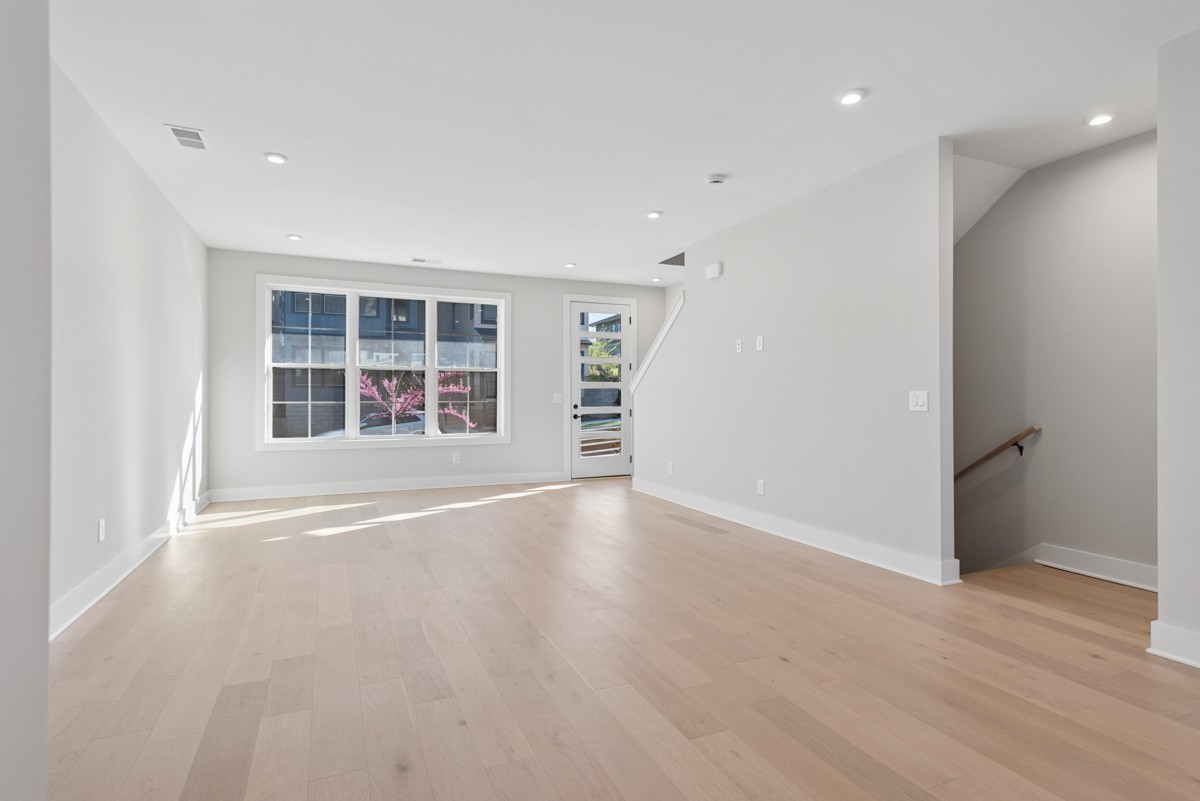 4 D Trimble Street Nashville, TN 37210 - Photo 7 of 53 an empty room with wooden floor and windows