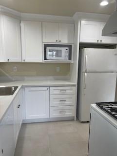 933 Rollins Road, Unit 4 Burlingame, CA 94010 - Photo 2 of 9 a kitchen with white cabinets and white appliances
