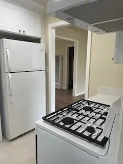 a stove top oven sitting inside of a kitchen