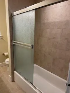 a bathroom with a shower and a toilet