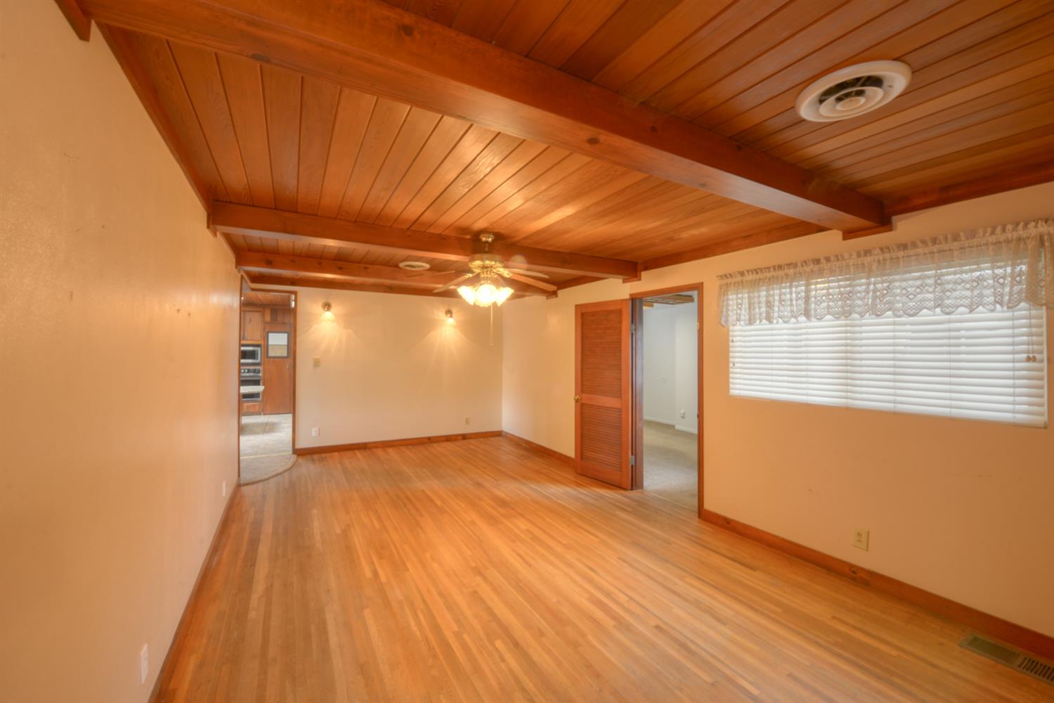 2931 East Marshall Road Patterson, CA 95363 - Photo 15 of 54 Dining Room and Family room with Wood Floors, Wood Beam Ceiling and Ceiling fan