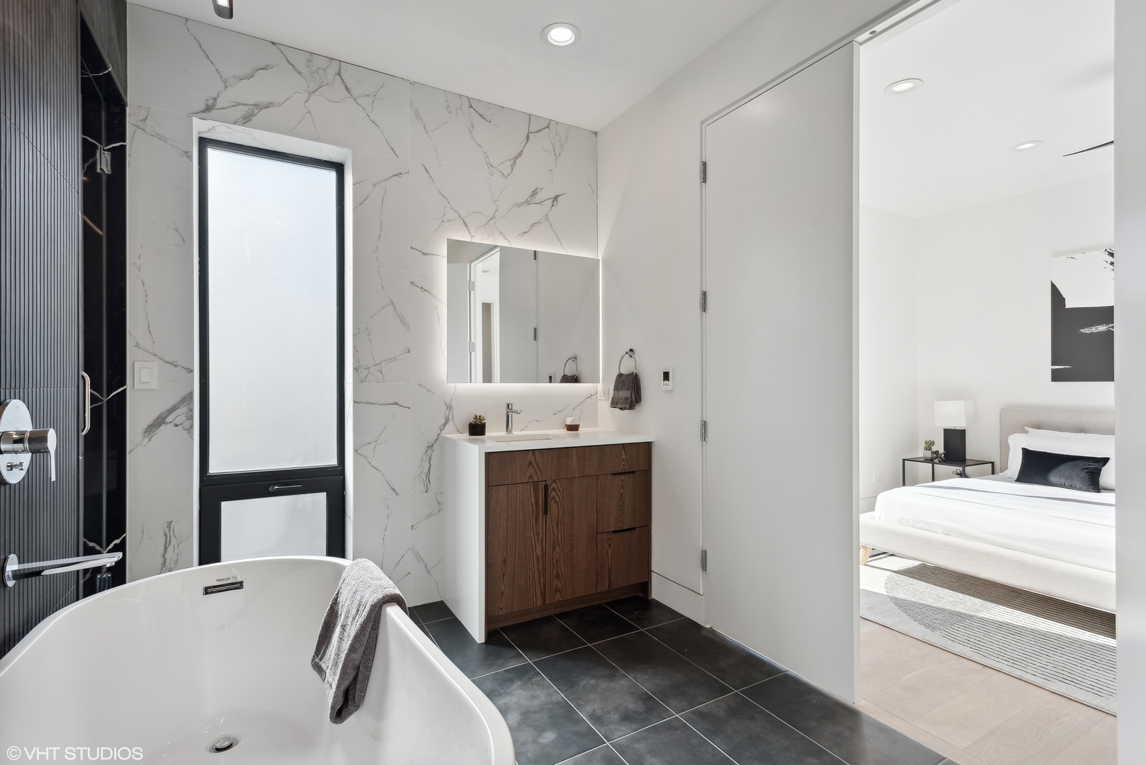 Undisclosed Address Chicago, IL 60657 - Photo 17 of 39 a bathroom with a bathtub sink and mirror