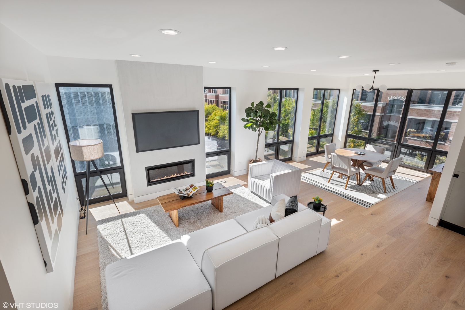 Undisclosed Address Chicago, IL 60657 - Photo 22 of 39 a living room with furniture a flat screen tv and a floor to ceiling window