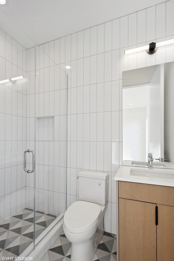 Undisclosed Address Chicago, IL 60657 - Photo 31 of 39 a bathroom with a granite countertop sink toilet and shower