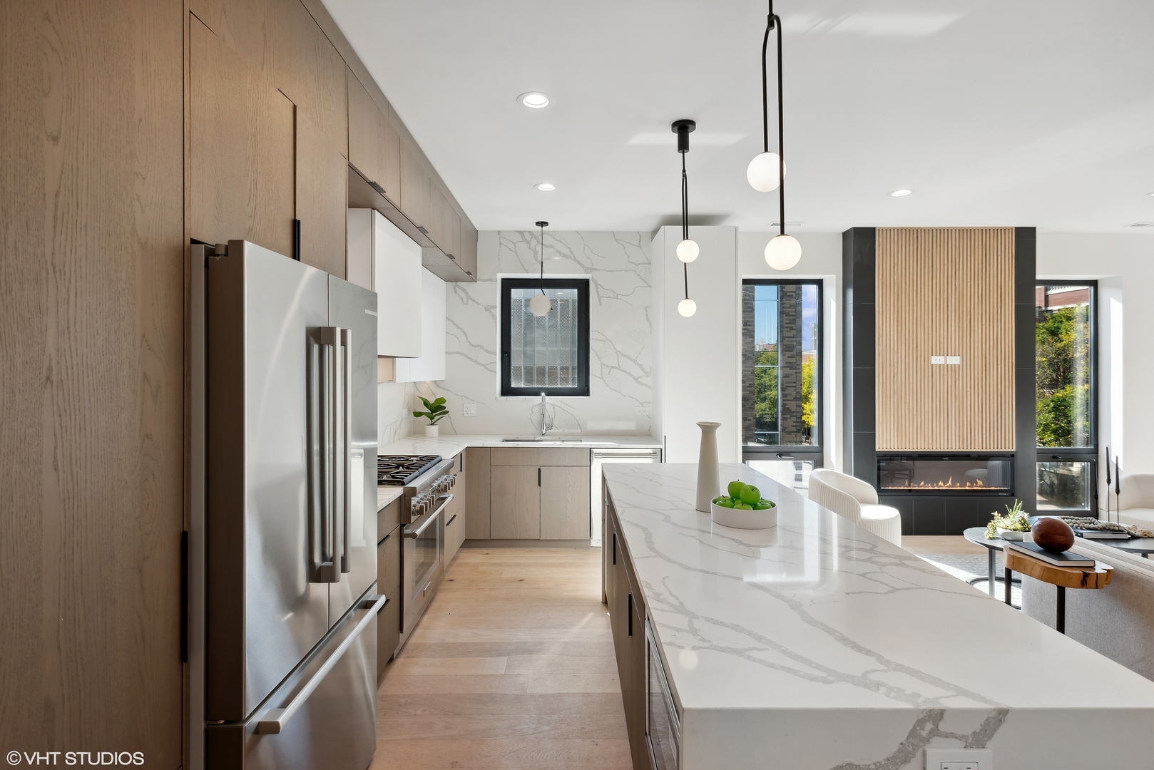 Undisclosed Address Chicago, IL 60657 - Photo 6 of 39 a large kitchen with a table chairs refrigerator and a sink