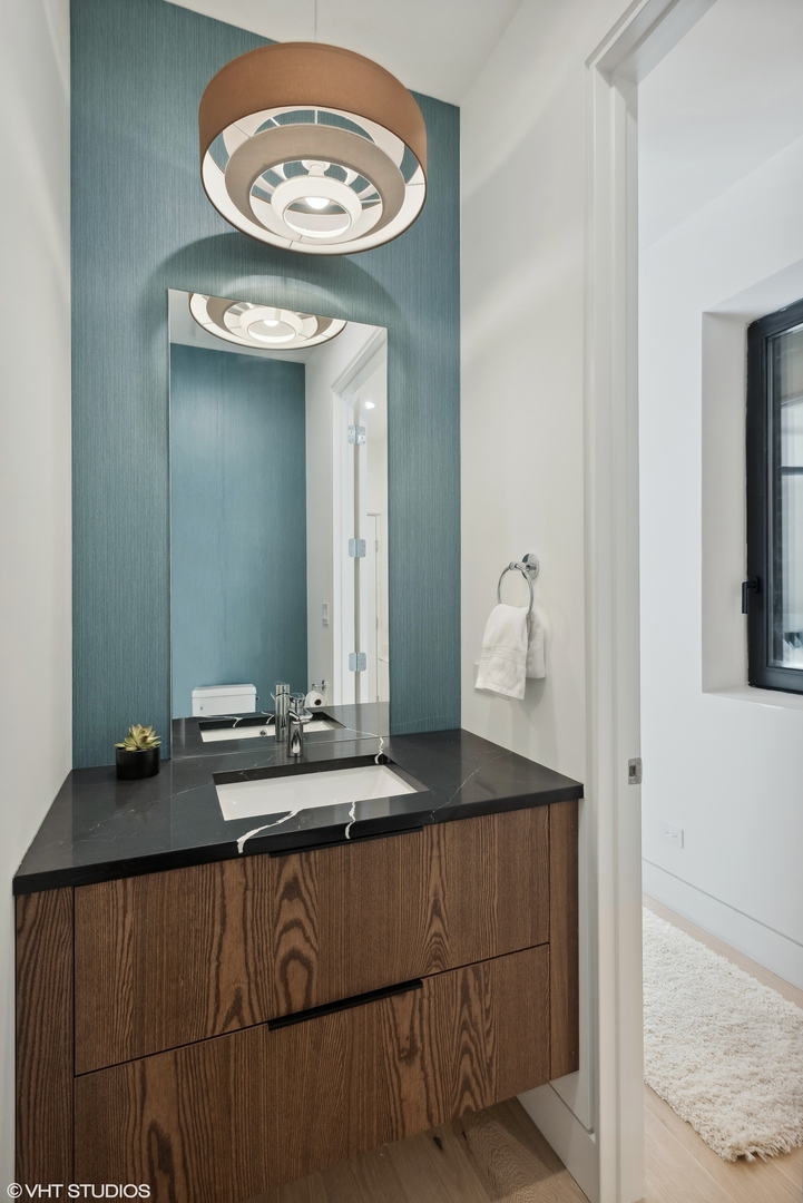 Undisclosed Address Chicago, IL 60657 - Photo 10 of 39 a bathroom with a sink and a mirror