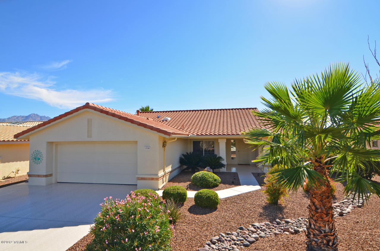 1330 East Crown Ridge Drive Tucson, AZ 85755 - Photo 22 of 22 a front view of a house with a yard