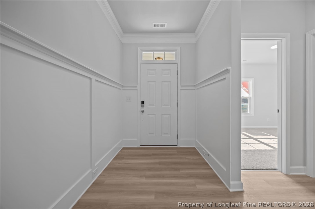 151 Michter Street Vass, NC 28394 - Photo 16 of 47 a view of a hallway with wooden floor and entryway