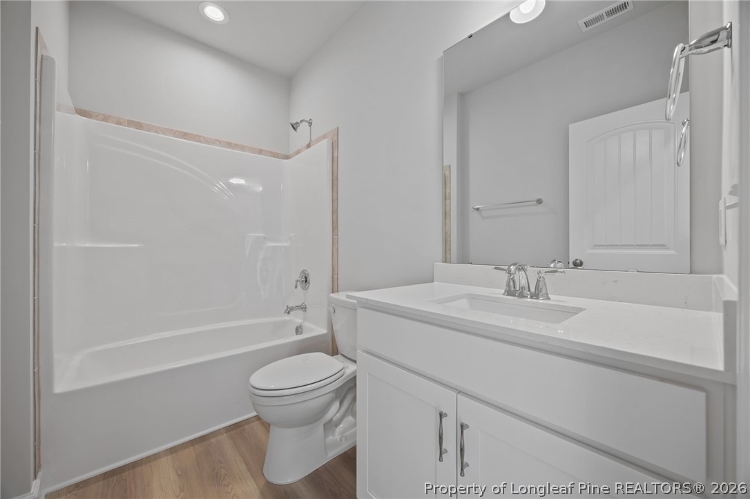 151 Michter Street Vass, NC 28394 - Photo 19 of 47 a bathroom with a sink a toilet and a large mirror