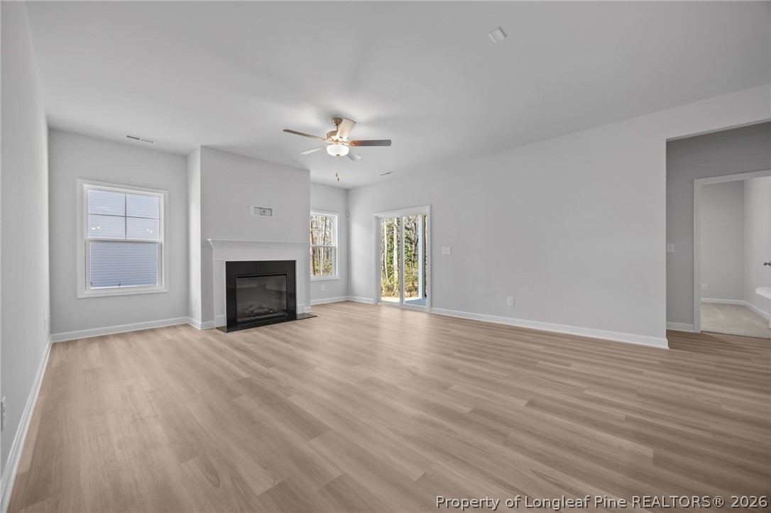 151 Michter Street Vass, NC 28394 - Photo 23 of 47 a view of empty room with wooden floor and fireplace