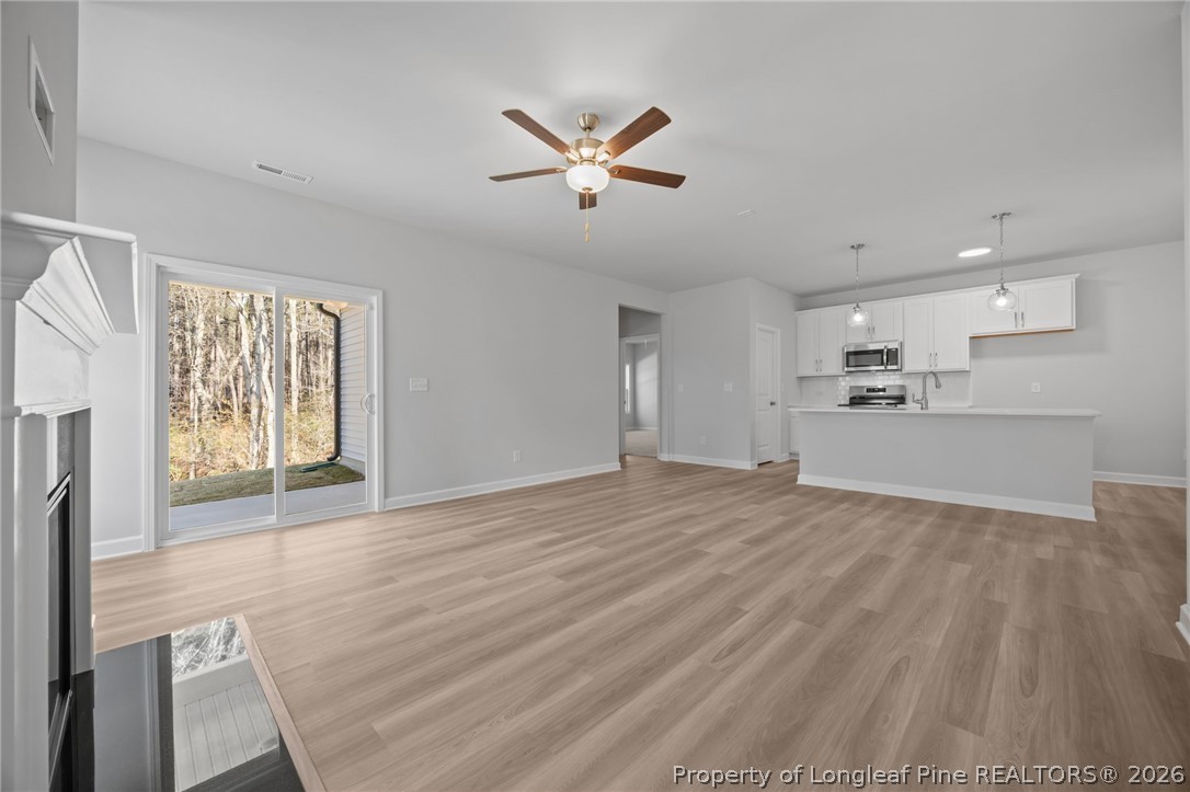 151 Michter Street Vass, NC 28394 - Photo 24 of 47 a view of empty room with wooden floor and window