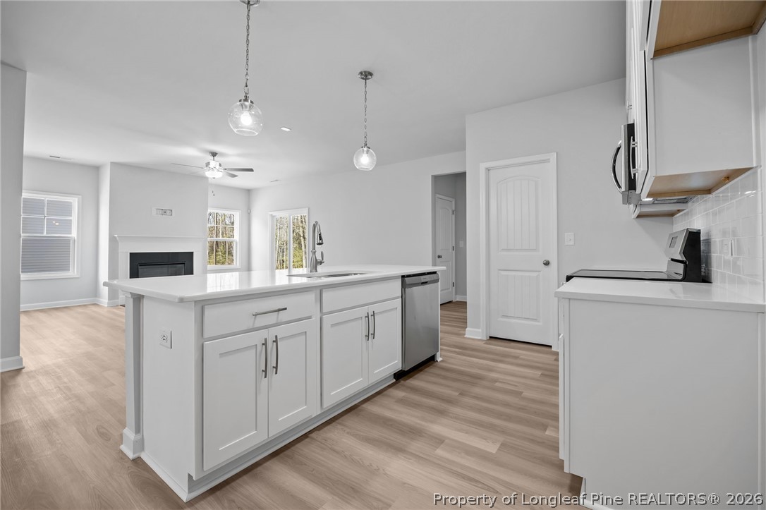 151 Michter Street Vass, NC 28394 - Photo 31 of 47 a large white kitchen with a sink a refrigerator and a stove