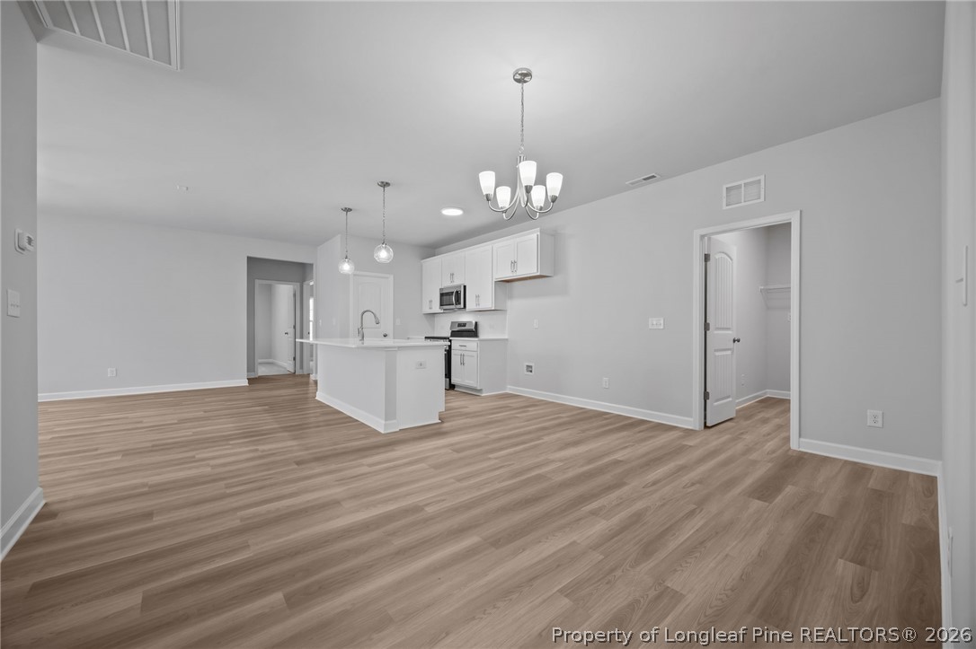 151 Michter Street Vass, NC 28394 - Photo 32 of 47 a view of a livingroom with a kitchen counter tops and wooden floor