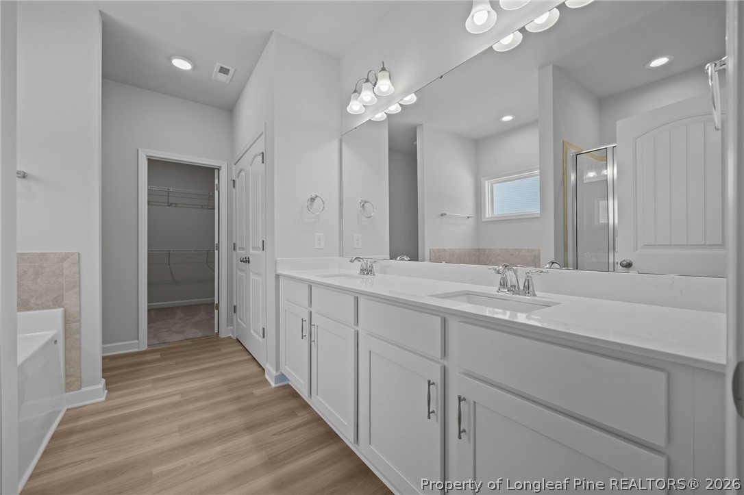 151 Michter Street Vass, NC 28394 - Photo 38 of 47 a bathroom with a double vanity sink and a mirror