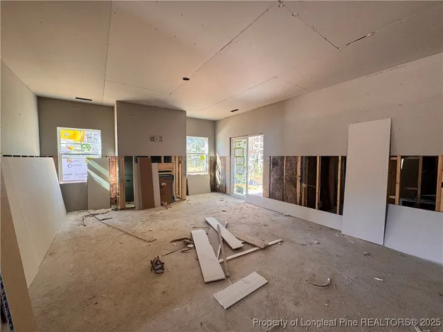 a spacious bedroom with a large bed and a dresser