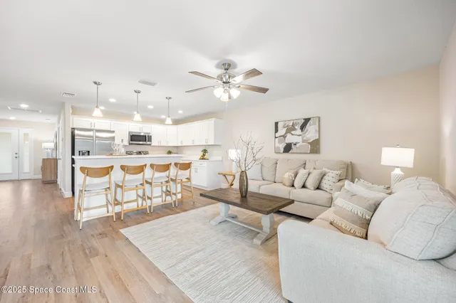 a living room with furniture and kitchen view