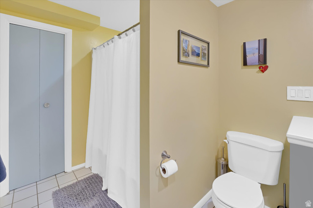 510 Spring Creek Road Providence, UT 84332 - Photo 48 of 97 Bathroom featuring a white toilet, tile flooring, and a shower with a white curtain