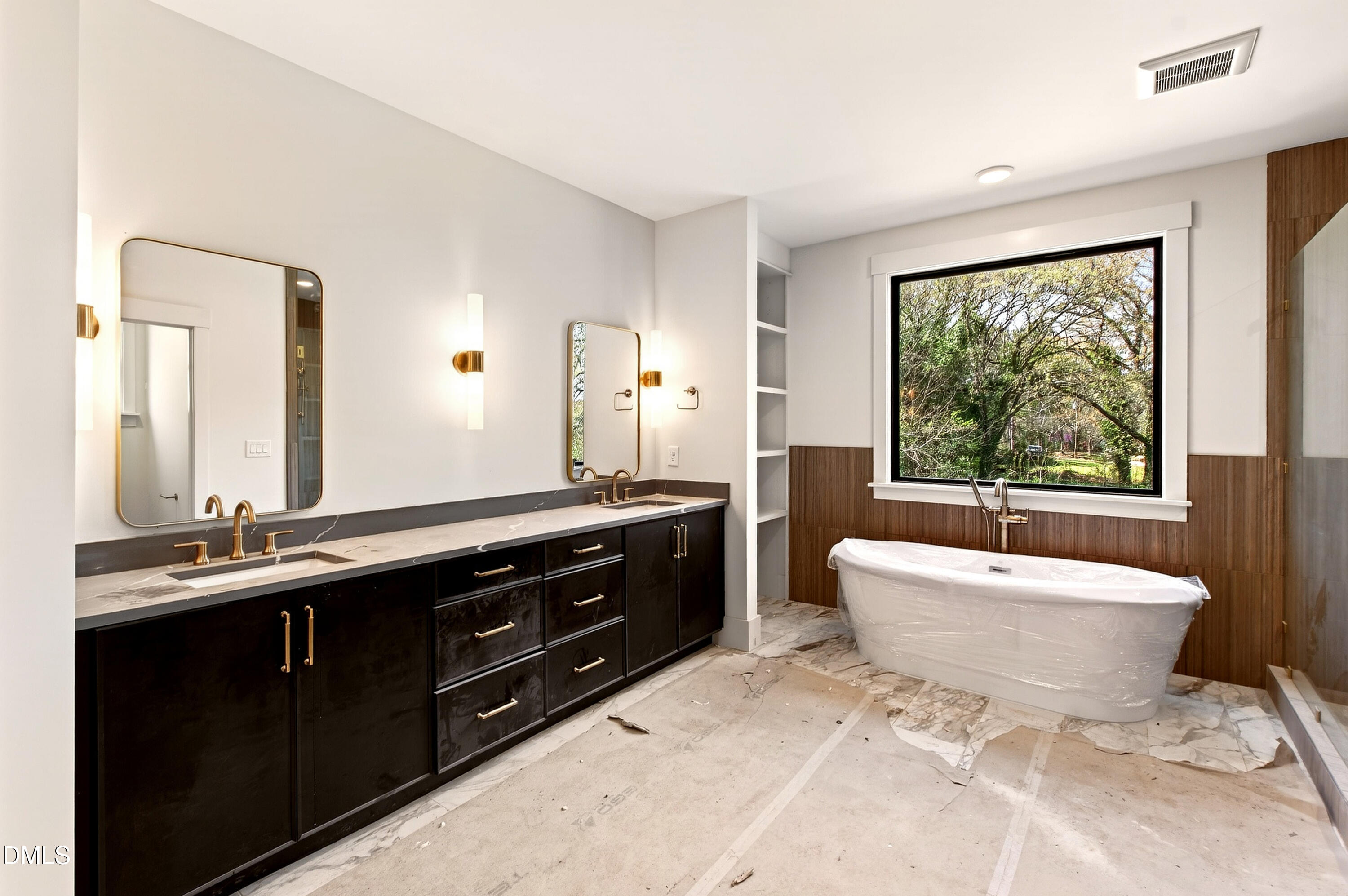 909 Oberlin Road Raleigh, NC 27605 - Photo 21 of 59 a spacious bathroom with a double vanity sink a large mirror a toilet a bathtub and window