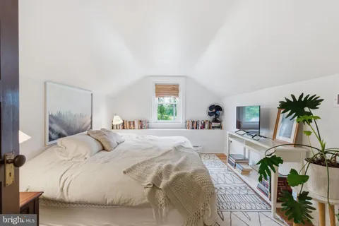 a bedroom with a large bed and a large window