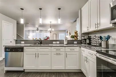 a kitchen with white cabinets and white appliances