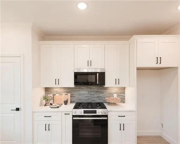 a kitchen with cabinets stainless steel appliances and a counter space