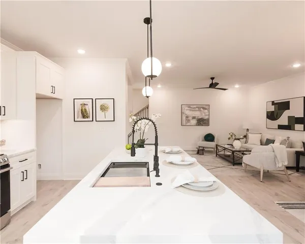 a living room with furniture a chandelier and a flat screen tv