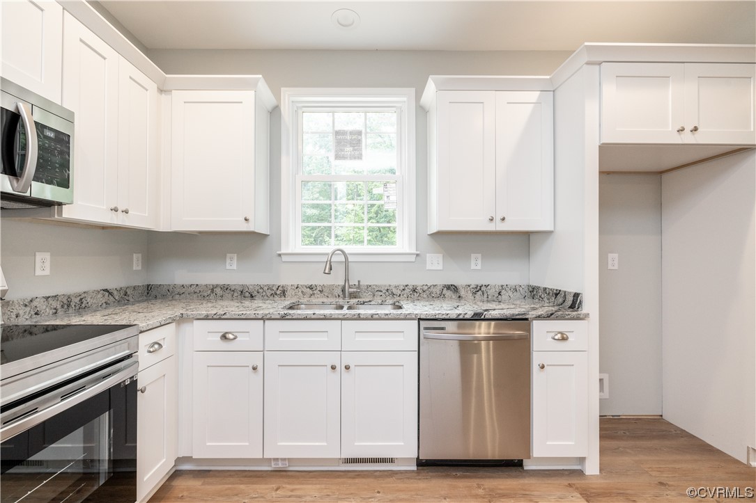 76 Trents Mill Road Cumberland, VA 23040 - Photo 12 of 36 a kitchen with granite countertop cabinets stainless steel appliances and a window